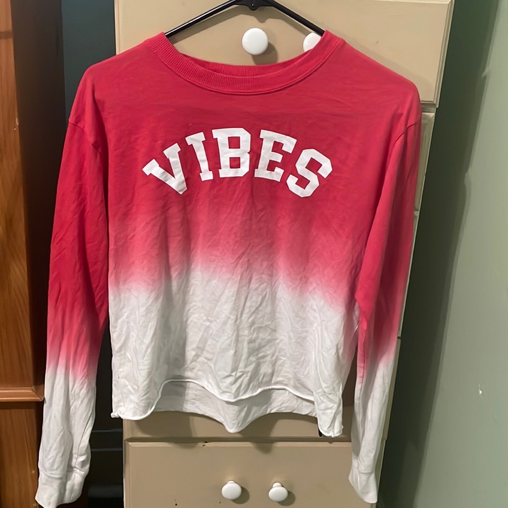 No Boundaries long sleeved cropped top that is two toned with red and white.